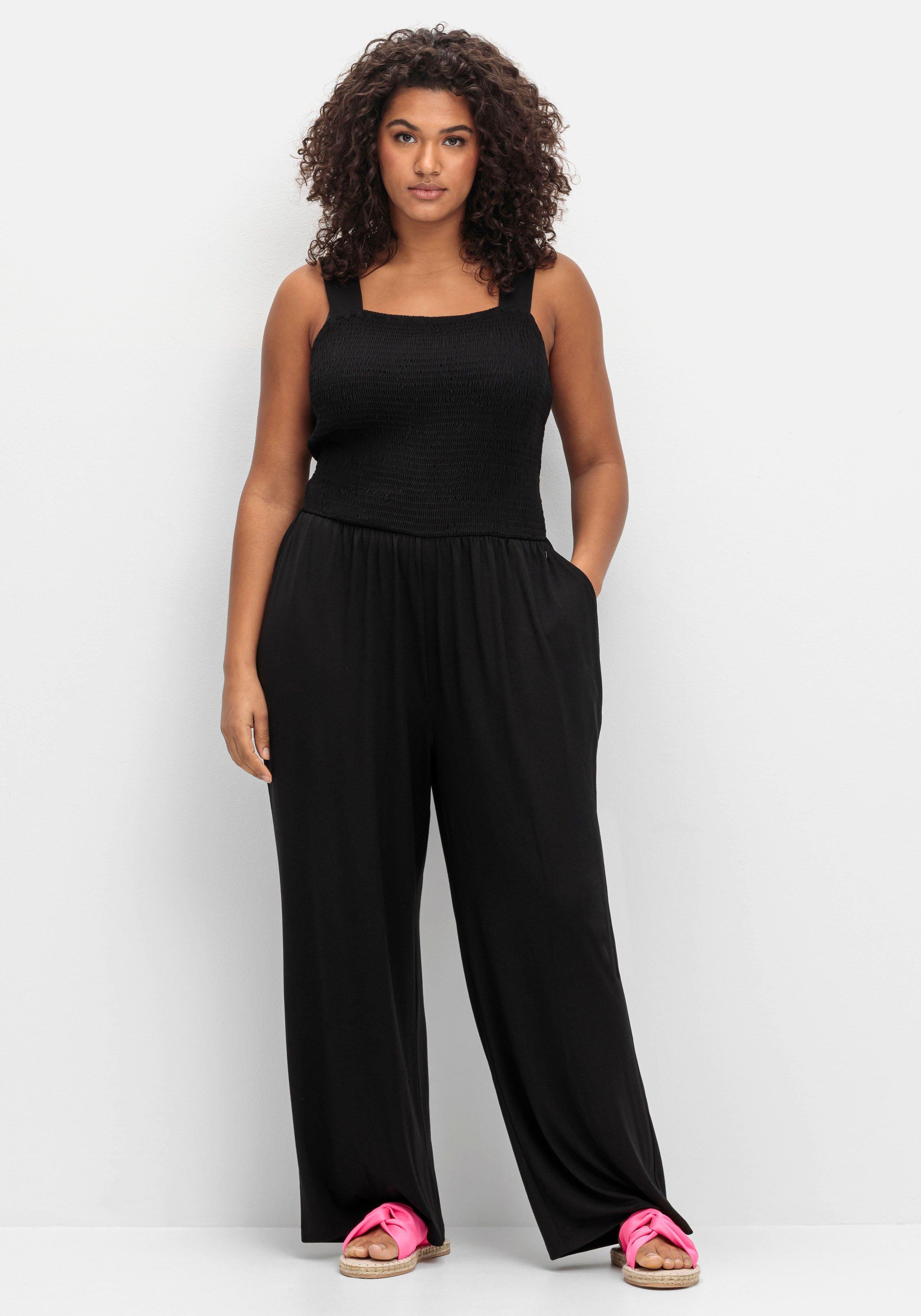 sheego Jumpsuit mit Smok-Oberteil und weitem Bein - schwarz sheego